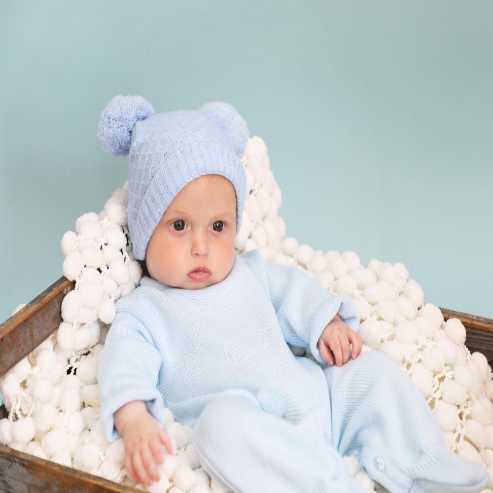 blue pom pom hat and matching bootees